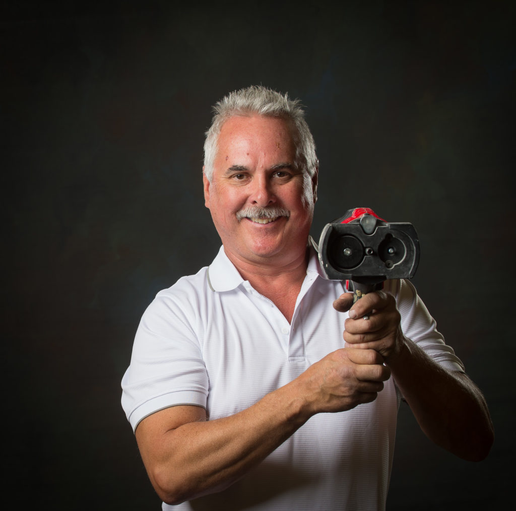 alt = technician posing with a 3M Dynamic Mixing System Gun